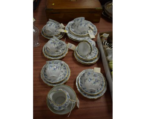 A Limoges floral and gilt pattern tea service for twelve, comprising: cream jug, sugar, tea cups and saucers, tea plates, san