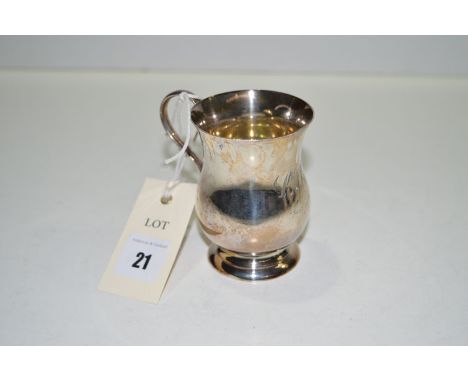A silver christening cup, by Henry Wilkinson, Sheffield 1910, of baluster form, with engraved initials and date.