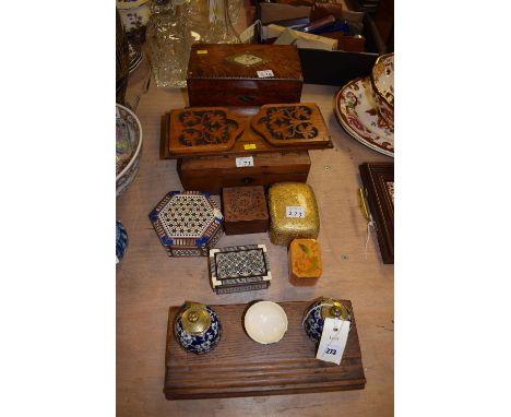 An early 20th Century oak ink stand with hawthorn ceramic ink holders; a Victorian walnut tea caddy with brass cartouche and 