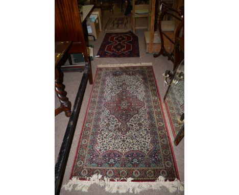 A Persian rug with medallion design; together with another prayer rug with chandelier central motif; and a machine-made rug o