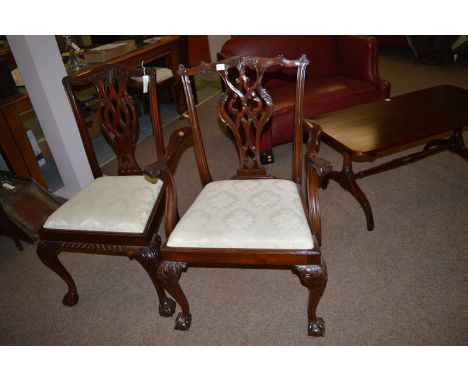 A set of six plus two reproduction mahogany Chippendale style dining chairs, with carved cresting rails and pierced and carve