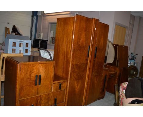 An Art Deco figured walnut four-piece bed room suite by C. W. S. Ltd, comprising: wardrobe, millinery cupboard, kneehole dres
