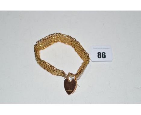 A yellow metal gate link bracelet of textured and plain form, with heart-shaped locket clasp stamped 'W & NS, 9ct'.