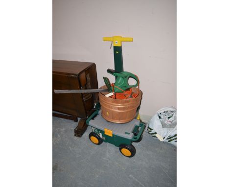 An electric hedge trimmer; a tool box on wheels; a sprinkler; etc.