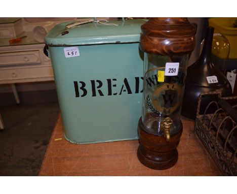 A green enamel bread bin; and a whisky decanter with brass top.  (2)