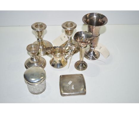 Silver items, to include: a pair of dwarf candlesticks; a cigarette case; a spill vase; a single candlestick; a cut glass and