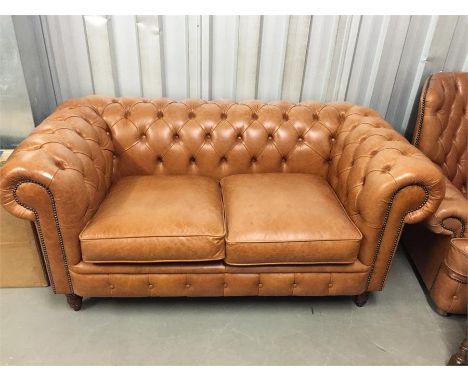 Button back brown leather sofa