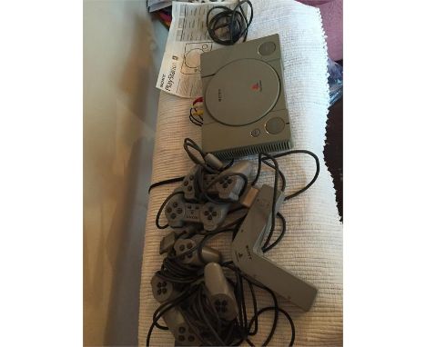 Playstation 1 model SCPH-1002 console and 4 controllers