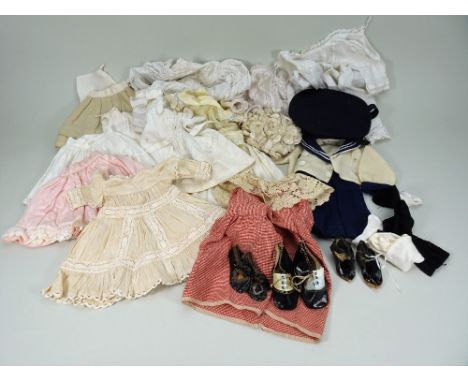 Collection of various dolls dresses and shoes, including a navy and cream flannel sailor style skirt, jacket and beret, to fi