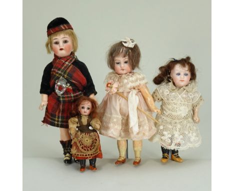 Four miniature bisque head dolls, German circa 1905, including all original traditional Scottish K&amp;R with brown glass eye