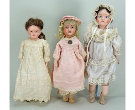 Three English bisque head dolls, 1915-20, including a ‘Goss’ girl with painted features, blonde wig and on a cloth body with 