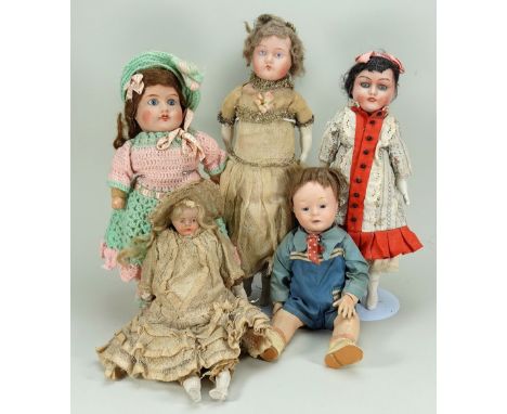 Five English bisque head dolls, 1915-20, including a ‘NTI English make’boy with blue glass eyes, painted mouth and brown wig,