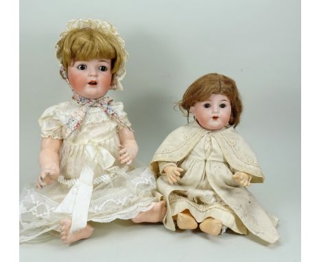 A.M 990 bisque head baby doll, circa 1915, with weighted brown glass eyes, open mouth with two upper teeth and brown wig, on 