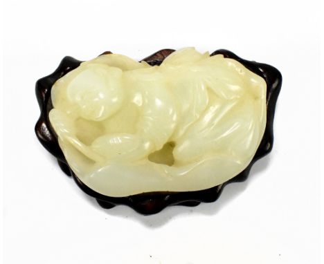 A Chinese jade carving depicting recumbent poet or scholar, probably Li Bai, holding citrus fruit, with further detail to und