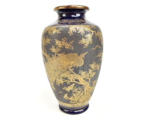 A Japanese Satsuma Meiji period vase, decorated in gilt with a peacock perching on a branch, inside gilt scrolls and floral d