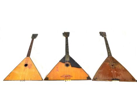 A cased balalaika and two others, one with back decorated with scene of Leningrad (3).Additional InformationPlease refer to t