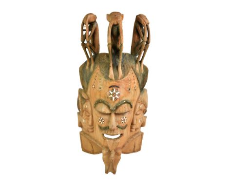 A massive early 20th century hardwood carved African mask based on a Fante Ghanaian example, the upper section set with 'See 