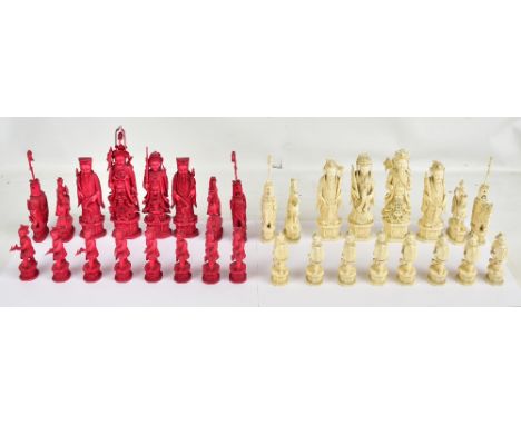 A good and large mid-19th century Chinese carved and stained ivory chess set with intricate detail throughout, the figures wi