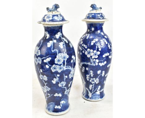 A pair of late 19th/early 20th century Chinese blue and white porcelain lidded vases decorated with blossoming prunus, six ch