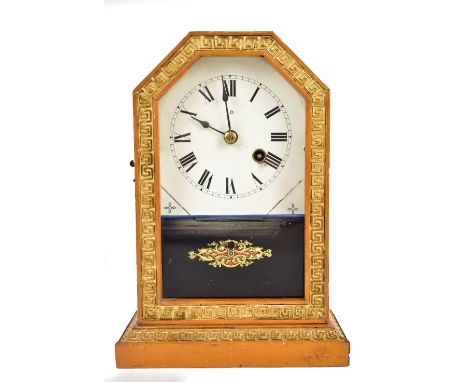 A late 19th century American mantel clock, the circular dial set with Roman numerals, housed behind glazed door with printed 