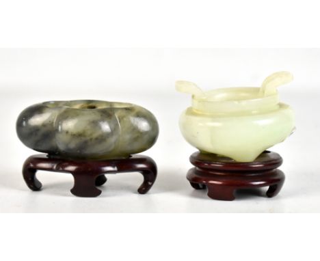 A Chinese polished hardstone quatrilobed brush washer, raised on shaped wooden stand, length 8cm, and a Chinese polished hard