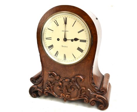 ADAMS OF LONDON; a 19th century pollard oak mantel clock, the circular dial set Roman numerals, with applied and carved folia