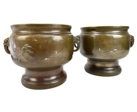 A pair of Japanese Meiji period twin handled bronze jardinières, each with white metal inlay and impressed decoration depicti