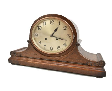 JUNGHANS OF WURTTENBERG; an early 20th century oak cased mantel clock with carved and beaded detail, movement back plate with