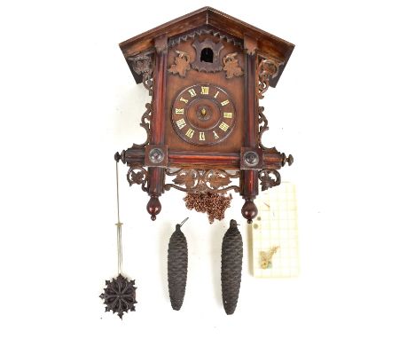 An early 20th century Black Forest cuckoo clock, the circular dial set with Roman numerals, height 42cm.Additional Informatio