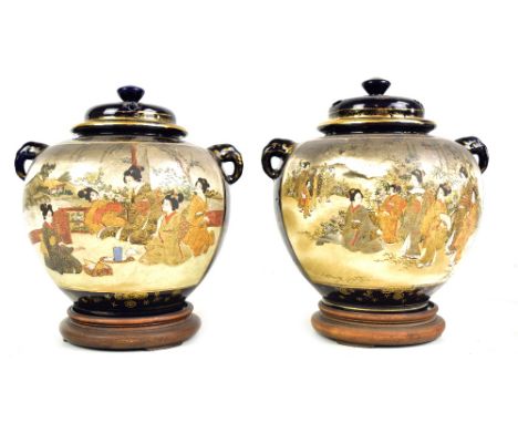 A pair of Japanese Meiji period Satsuma twin handled vases of bulbous form, each painted with geisha in landscape scenes, sig