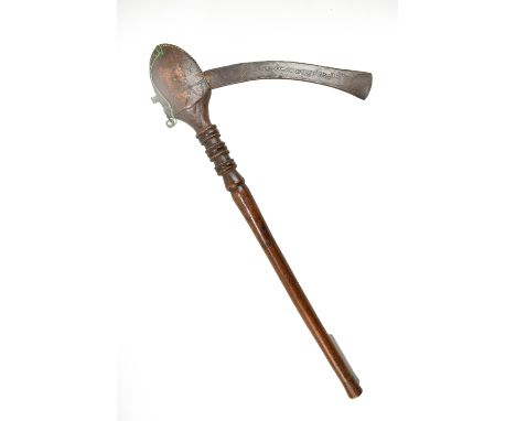 A Mozambique Tsonga ceremonial axe, with wimple decoration to the metal blade and turned wooden handle, height 50cm.Additiona