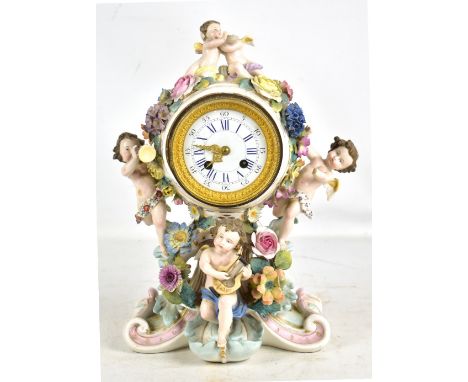 A late 19th century Continental porcelain floral encrusted mantel clock,&nbsp;the circular enamelled dial set with Roman and 