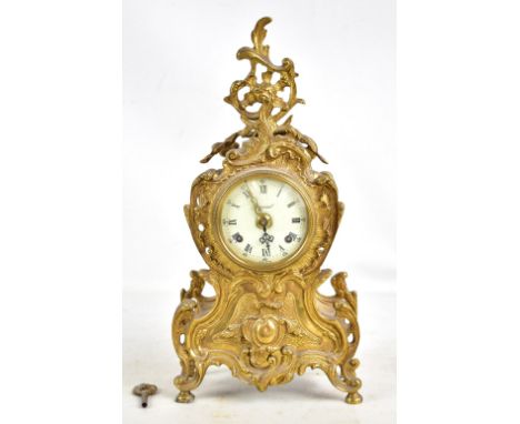 IMPERIAL; a reproduction gilt metal mantel clock, with pierced ornate decoration throughout, with circular dial with Roman an