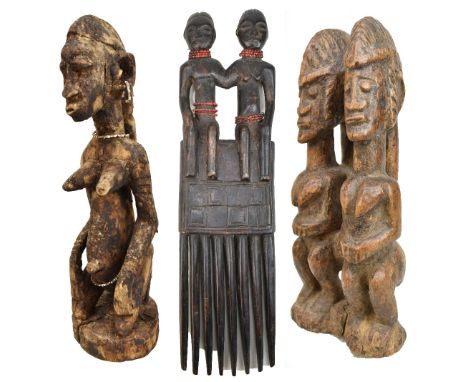 An African tribal carved double figure group, height 26cm, a carved double figure, length 40cm, and a further carved figure, 