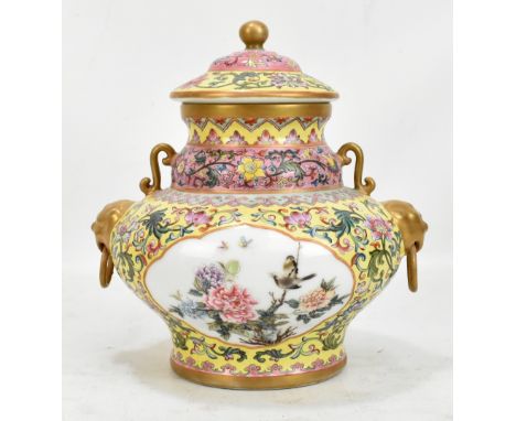 A 20th century Chinese lidded porcelain vase/vessel with twin gilt mask and loop handles featuring twin panels with birds amo