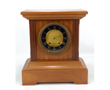 A late 19th/early 20th century mantel clock, the circular dial set with gilt Roman numerals, the movement backplate stamped '
