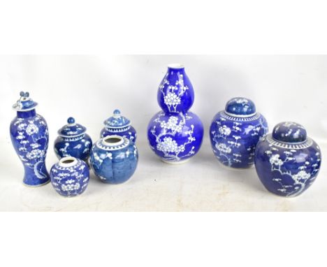 Eight pieces of late 19th/early 20th century Chinese blue and white porcelain, all decorated with prunus, comprising temple j