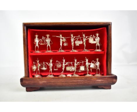 A cased set of twelve Chinese (or Hong Kong) sterling silver menu holders modelled as traditional Chinese workers and porters