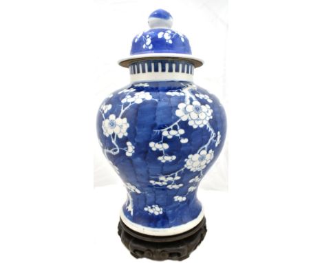 A late 19th/early 20th century Chinese porcelain blue and white temple jar and cover, decorated with prunus, with Kangxi doub