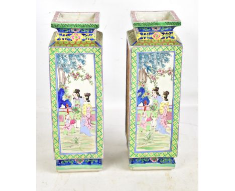 A pair of 20th century Chinese porcelain square section vases, each featuring enamelled panels of ladies in garden setting an