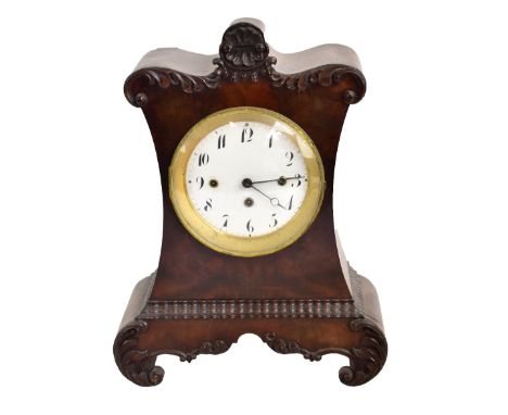 A William IV mahogany mantel clock, with carved detail surrounding the circular enamelled dial set with Arabic numerals, with