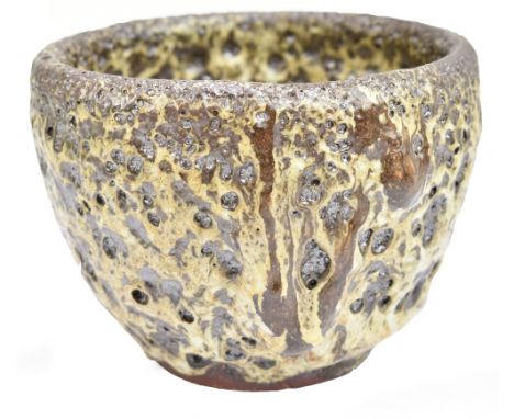 A Japanese earthenware bowl with thick cream and brown eruption glaze, three character mark to base, 11.4 x 15.4cm.Additional