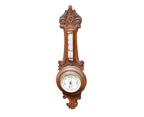 BOTLY &amp; LEWIS OF READING; an early 20th century carved oak combination aneroid barometer and thermometer with ceramic cen