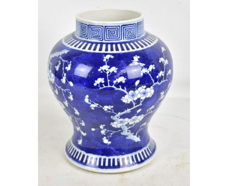 A late 19th/early 20th century Chinese baluster vase painted in underglaze blue with blossoming prunus to body and Greek key 