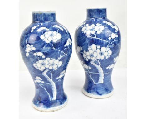 A pair of late 19th/early 20th century Chinese blue and white baluster vases with painted four character marks to the bases, 