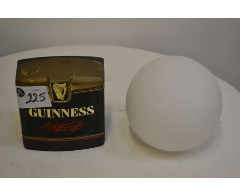 Guinness beer pump sign and suspended light glass globe