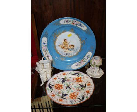 A VINTAGE HAND PAINTED CHERUBIC CABINET PLATE TOGETHER WITH A FLORAL EXAMPLE WITH CROSS SWORD BACK STAMP AND TWO CERAMIC POSY