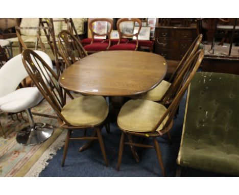 AN ERCOL OAK DRAWLEAF DINING TABLE WITH FOUR 'SWAN BACK' HOOPED CHAIRS