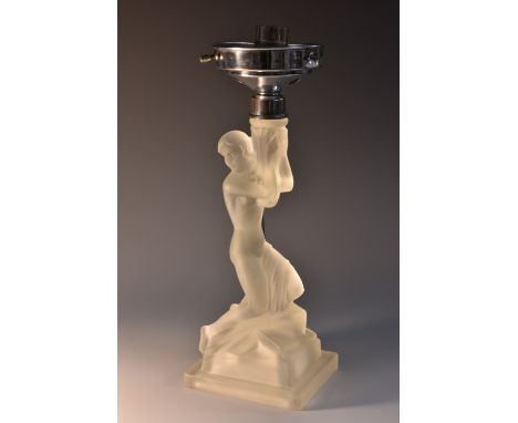 An Art Deco frosted glass figural table lamp, moulded as a scantily clad female, kneeling, on a stylised geometric rocky out 