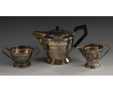 An Art Deco style E.P.N.S three piece tea service, comprising teapot, milk jug and sugar basin, of stepped geometric design, 